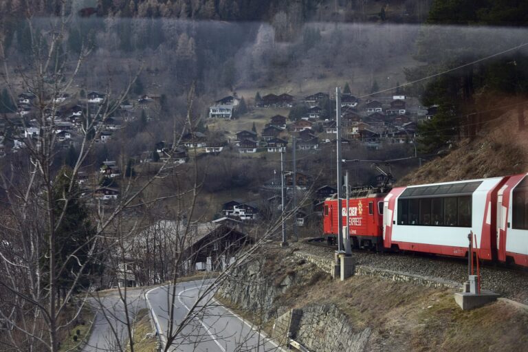 The Glacier Express winding through an Alpine village